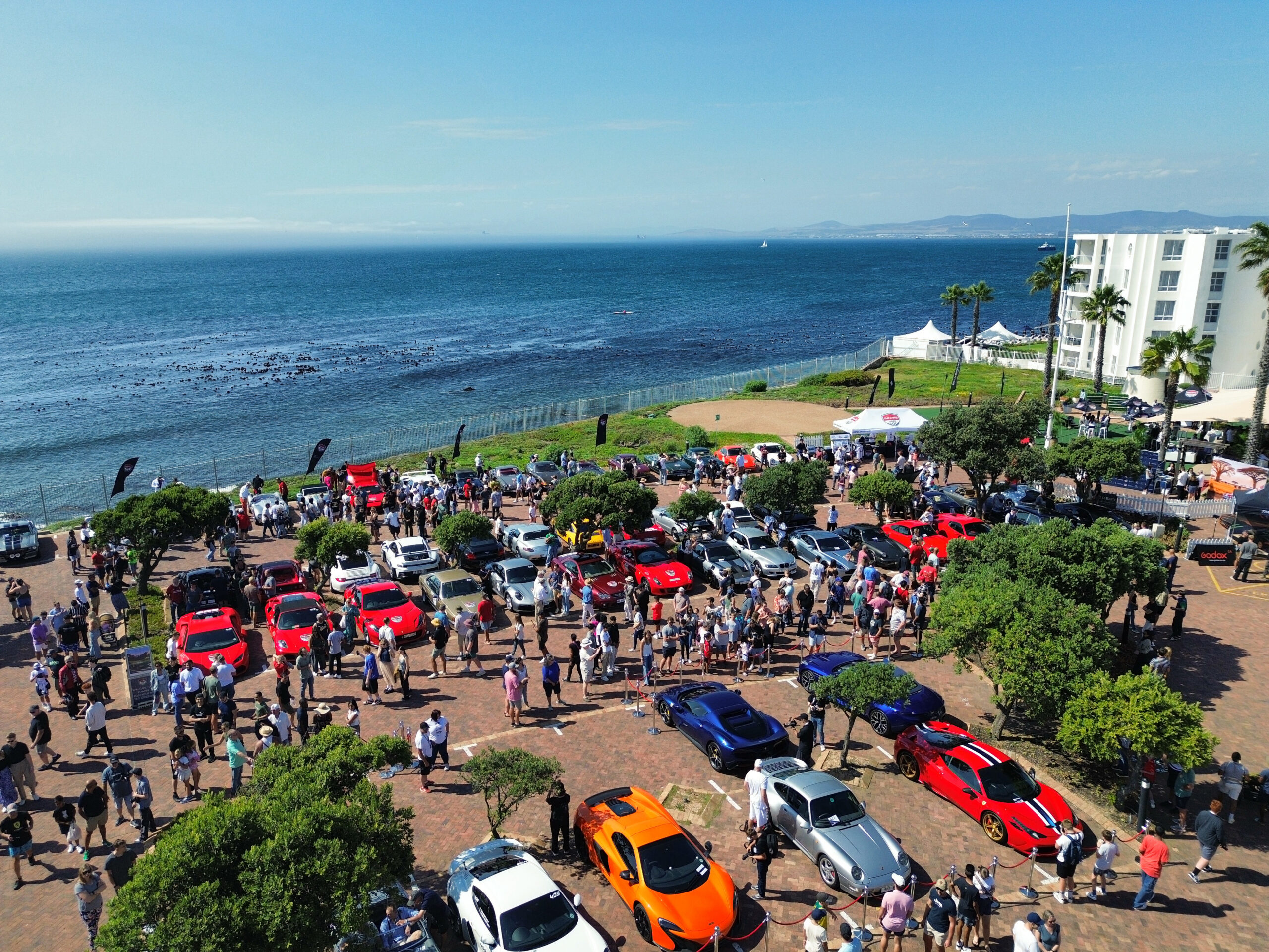 Cape 1000 2026 Show & Shine at the Cape Town Hotel School in Cape Town, featuring classic cars, supercars, spectators, and ocean views.